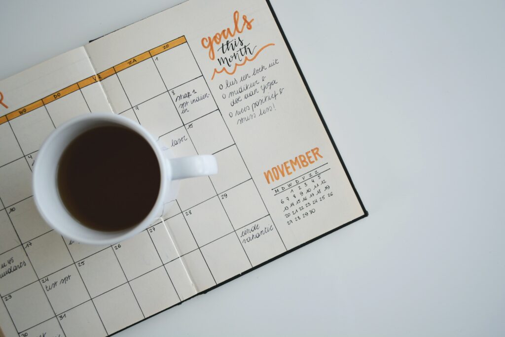 Top down image of coffee, daily planner