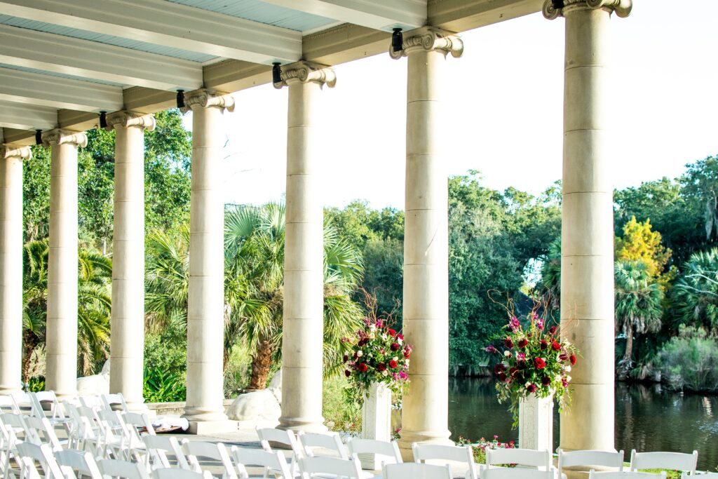 destination wedding venue, white columns, white chairs, green forest