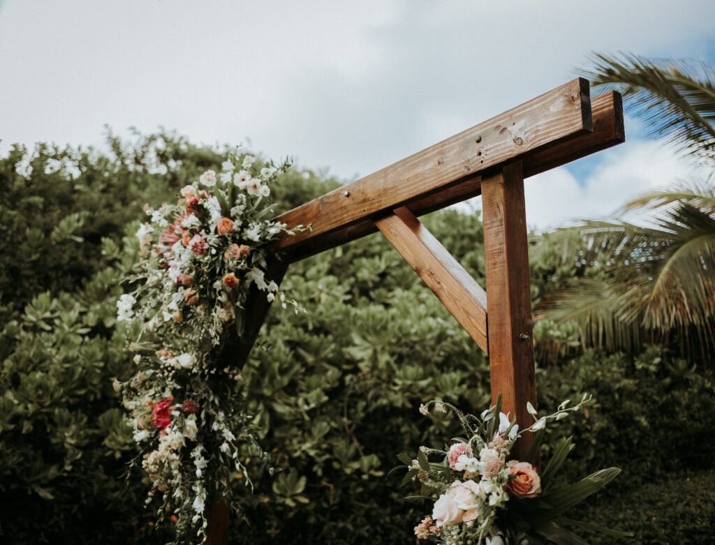 DIY wooden arch, with wedding florals on a corner